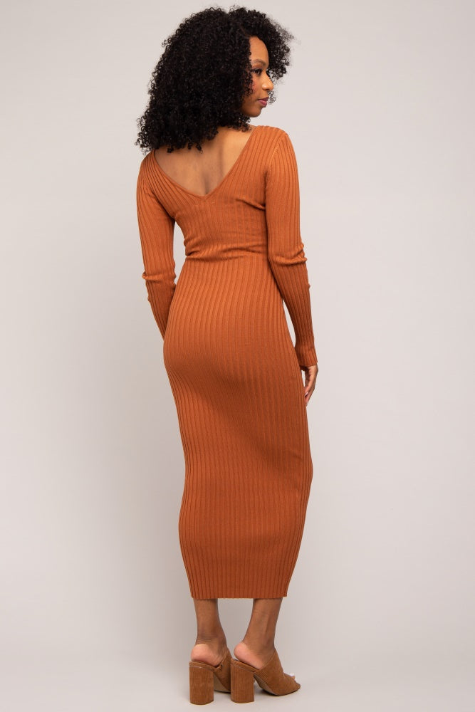 woman wearing a ribbed rust-colored midi dress with a deep v-back and long sleeves