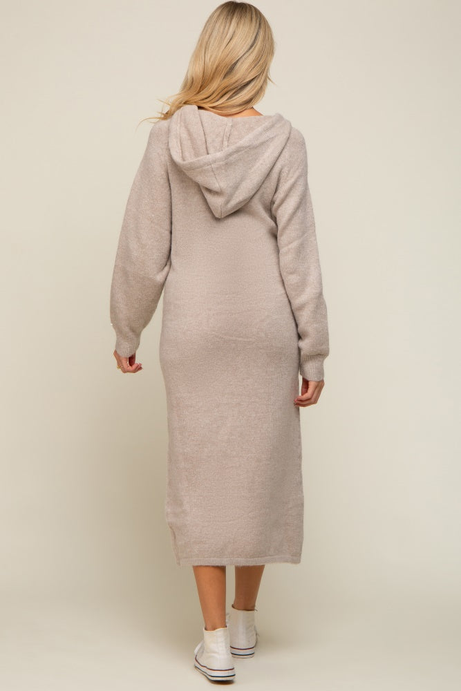 woman wearing a beige maternity long sleeve hoodie dress, showing a slim fit and knee-length design from the back