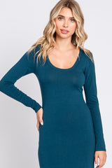 woman wearing a teal long sleeve scoop neck dress with a fitted style