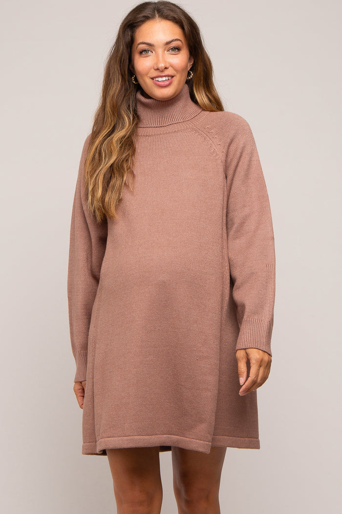 woman wearing a mauve turtleneck maternity dress with long sleeves and a relaxed fit, baby bump visible