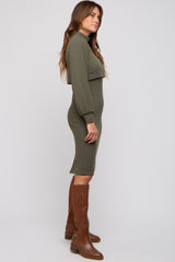 woman wearing an olive green ribbed midi dress with long sleeves and brown knee-high boots