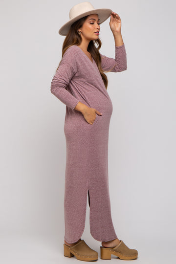 woman wearing a mauve long sleeve maternity maxi dress with pockets and a side slit, showcasing her baby bump