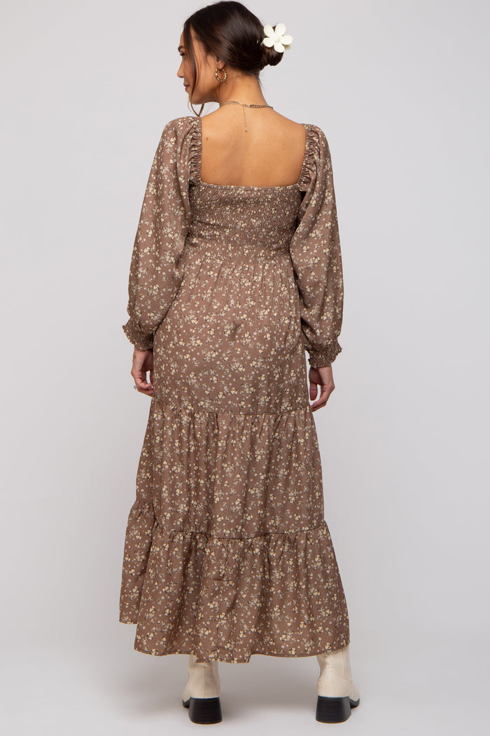 woman wearing a brown floral maternity maxi dress with smocked bodice and long sleeves