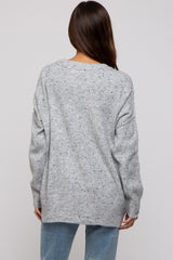 woman wearing a loose grey knit maternity sweater with a relaxed fit and dropped shoulder seams, back view