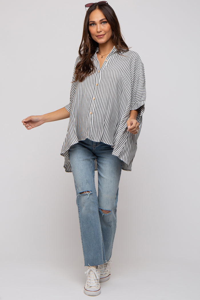 woman wearing a striped maternity top with button details and paired with ripped blue jeans