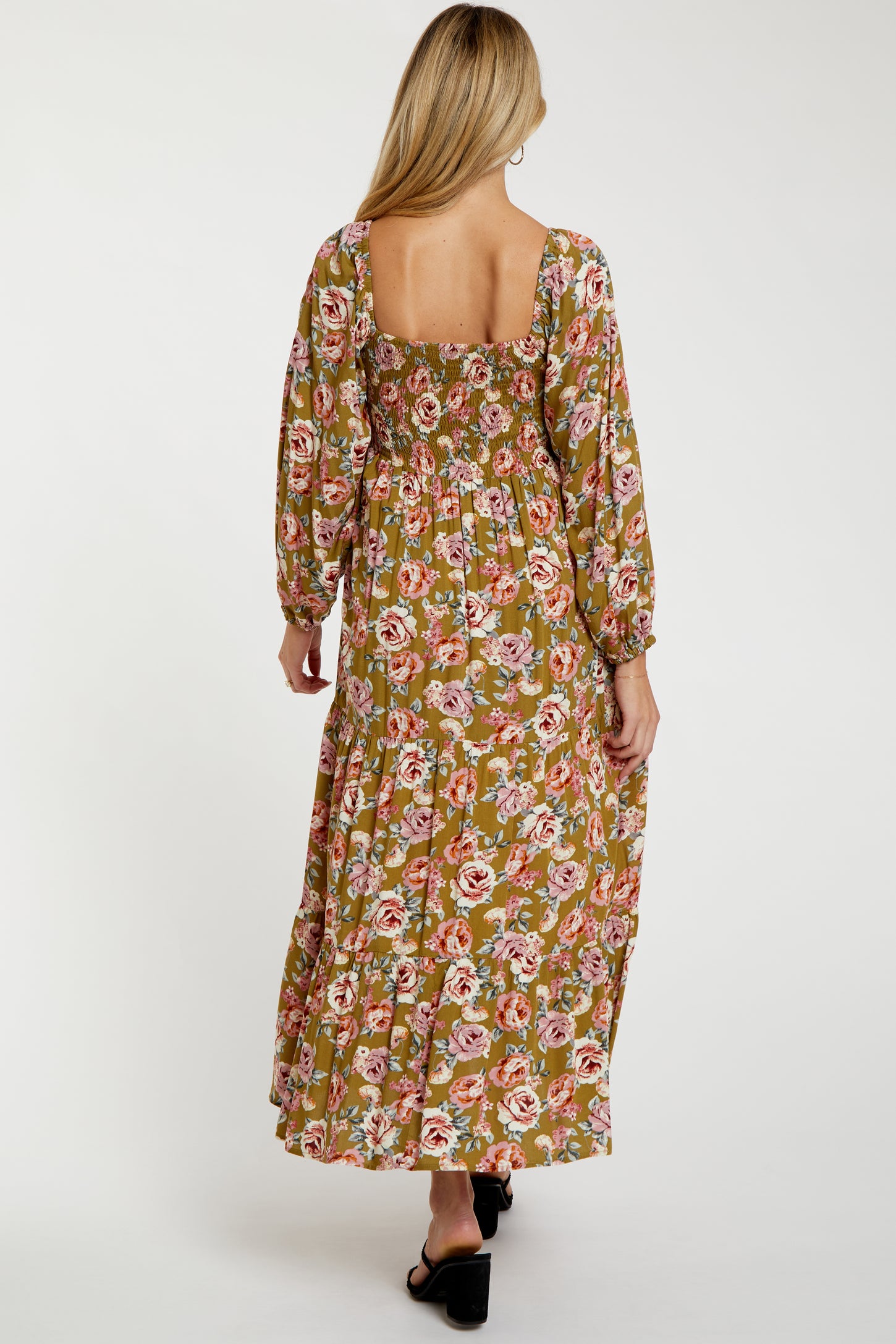 woman wearing a floral print maternity maxi dress with long sleeves and a square back style