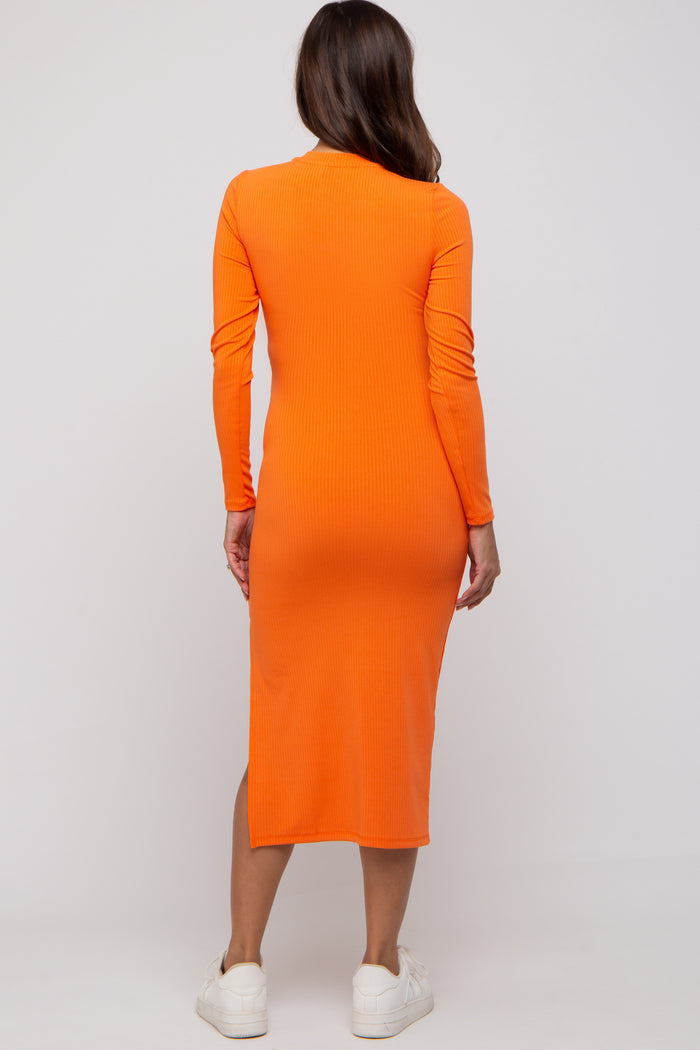 woman wearing a long orange ribbed maternity dress from the back with long sleeves and a fitted silhouette