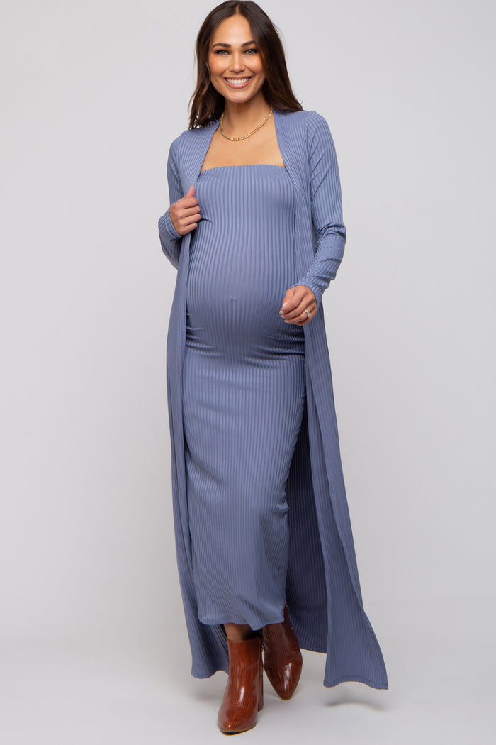 woman wearing a light blue ribbed maternity maxi dress with a matching duster and showing her baby bump