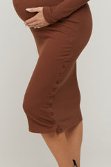 maternity wear brown ribbed midi dress with button detail and a visible baby bump