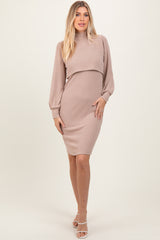 woman wearing a taupe ribbed long sleeve dress with a mock neck and fitted silhouette