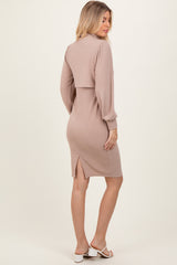 woman wearing a taupe ribbed long sleeve dress with a cropped top and back slit