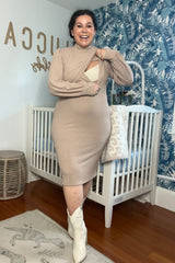 woman wearing a beige long sleeve maternity dress with a fitted silhouette and a visible baby bump
