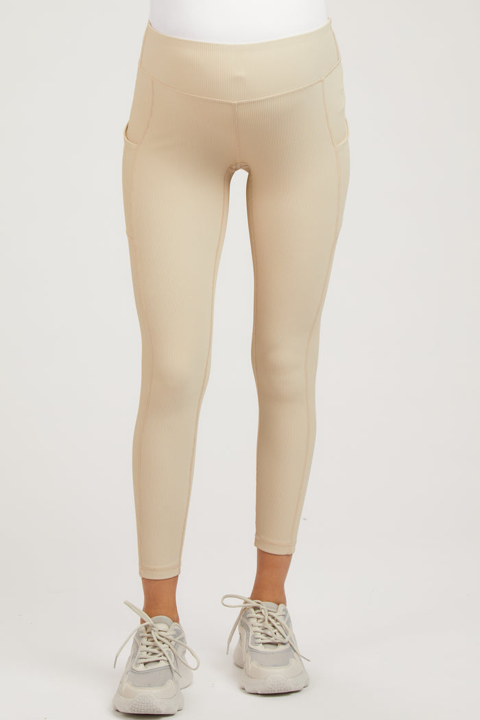 maternity wear in beige ribbed leggings with side pockets, model wearing sneakers