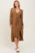 woman wearing a brown ribbed midi dress with a matching long cardigan and white slide sandals