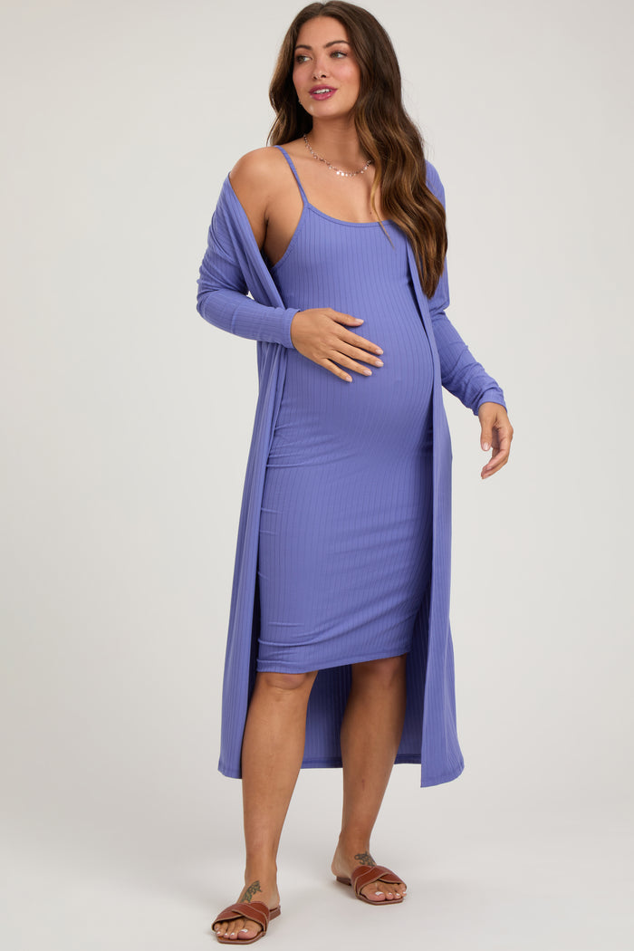 woman wearing a purple ribbed maternity dress with a long cardigan and showing her baby bump