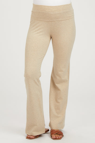 woman wearing beige maternity yoga pants with a wide waistband and flared legs