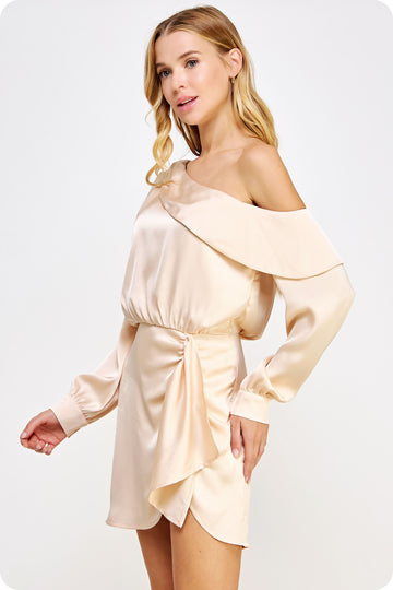 woman wearing a blush off-shoulder satin dress with long sleeves and a wrapped front detail