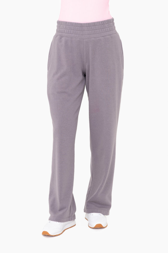 woman wearing gray fleece lounge pants with elastic waistband and side pockets