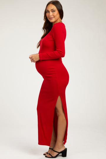 woman wearing a red ribbed long sleeve maternity dress with a side slit and showing her baby bump