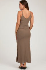 woman wearing a brown ribbed maxi maternity dress with a side slit, showing her baby bump from the back