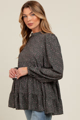 woman wearing a dark gray maternity top with pink and purple leopard print and tiered ruffle details