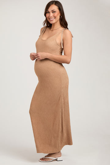 woman wearing a ribbed tan maternity maxi dress, showcasing her baby bump with thin adjustable straps