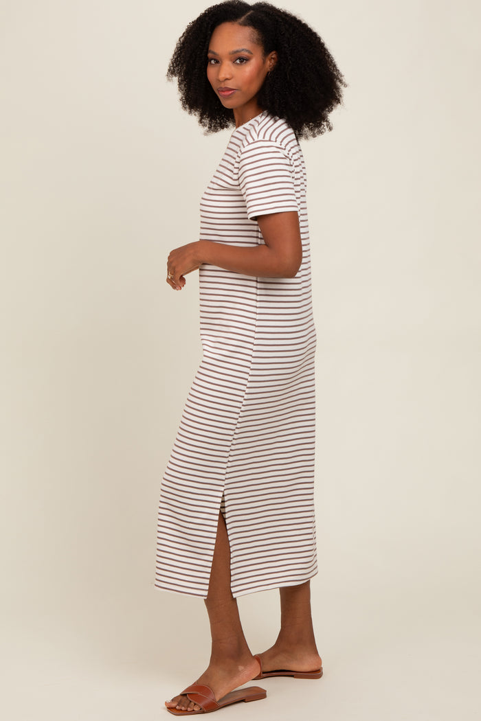 woman wearing a beige and white striped short sleeve maxi dress with side slits and brown sandals