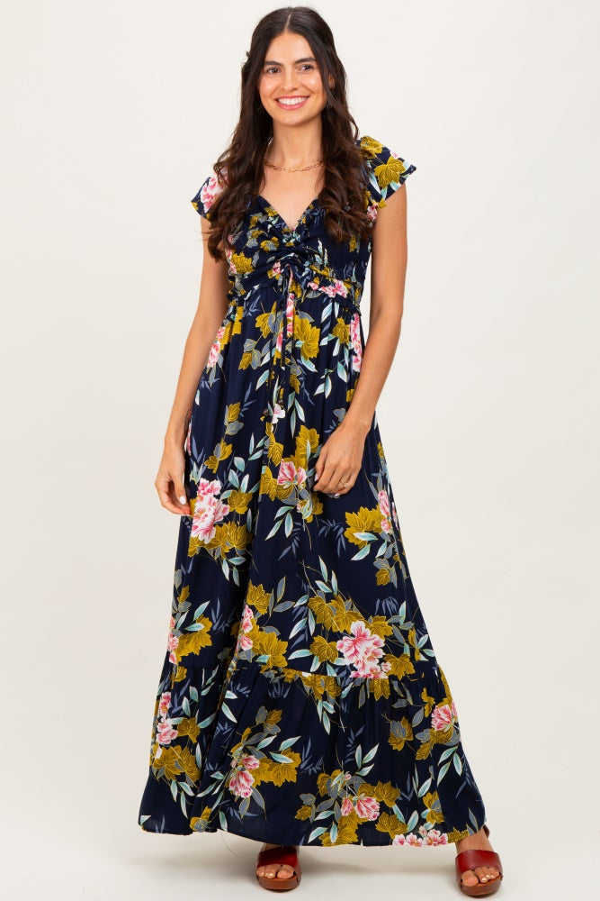 woman wearing a navy blue floral maxi dress with short ruffle sleeves and a cinched waist