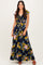 woman wearing a navy blue floral maxi dress with short ruffle sleeves and a cinched waist