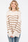 woman wearing a cream and brown striped oversized sweater with long sleeves and relaxed fit