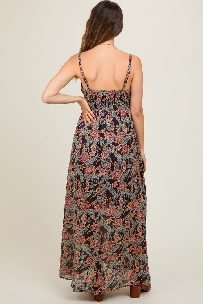 woman wearing a black floral maternity maxi dress with adjustable straps and a smocked back, showing her baby bump