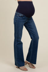 woman wearing dark blue maternity bootcut jeans with a supportive belly panel and visible baby bump