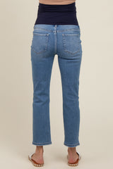 woman wearing a pair of blue maternity jeans, showing the back view with a fitted waist and straight leg cut