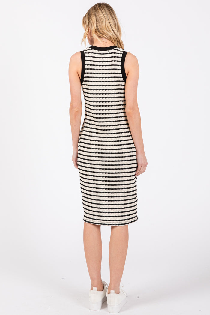 woman wearing a black and white striped sleeveless midi dress, view from the back