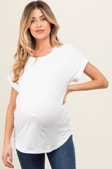 woman wearing a white short sleeve maternity top with a visible baby bump and blue jeans