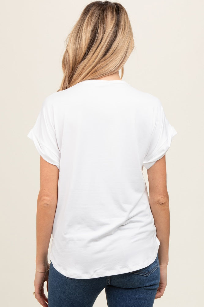 woman wearing a white short sleeve maternity top, viewed from the back, paired with blue jeans