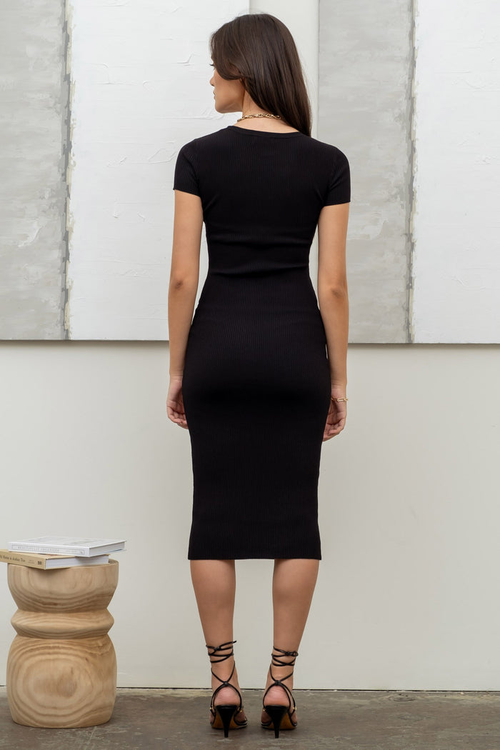 woman wearing a black ribbed midi dress with short sleeves and a fitted silhouette