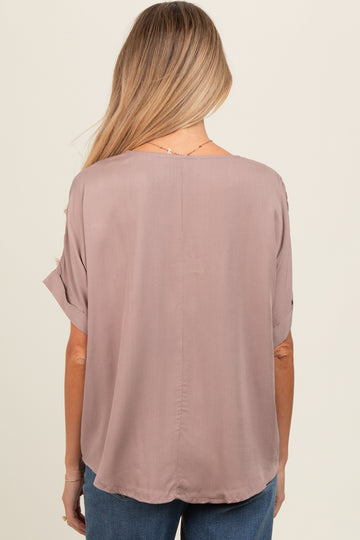 woman wearing a mauve short sleeve maternity top, featuring a relaxed fit and round hem with a smooth back design