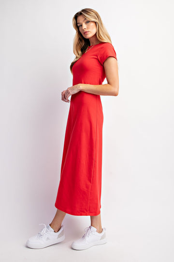 woman wearing a bright red short sleeve maxi dress styled with white sneakers