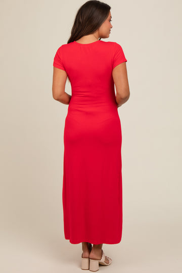 woman wearing a red short sleeve maternity maxi dress, view from the back
