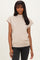 woman wearing a beige short sleeve ribbed mock neck top paired with black jeans