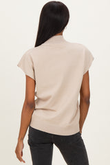 woman wearing a beige short sleeve sweater with a high neckline and a relaxed fit, viewed from the back
