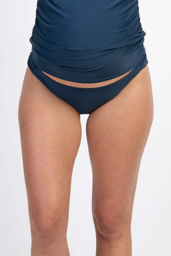maternity swim bottoms in navy blue with ruched detailing and a low-rise fit