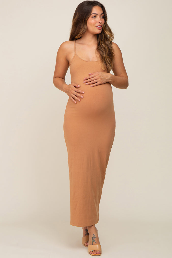 woman wearing a ribbed tan maternity maxi dress and holding her baby bump